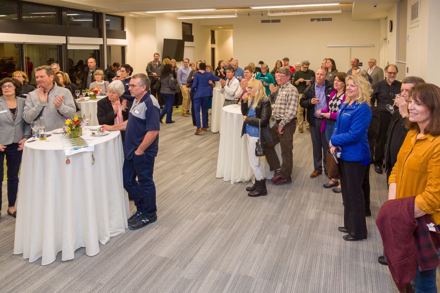 A crowd of well-dressed people at a silent auction fundraiser for the new library