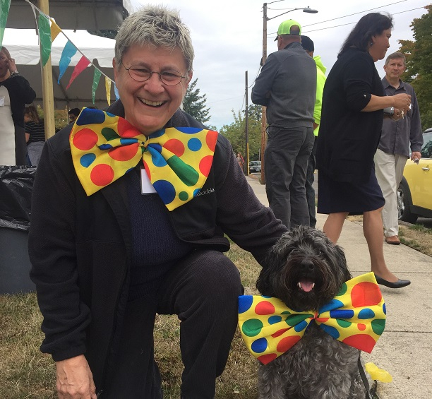 Lynn Baker, the Foundation Treasurer, and her dog smile at the camera in their silly bow ties